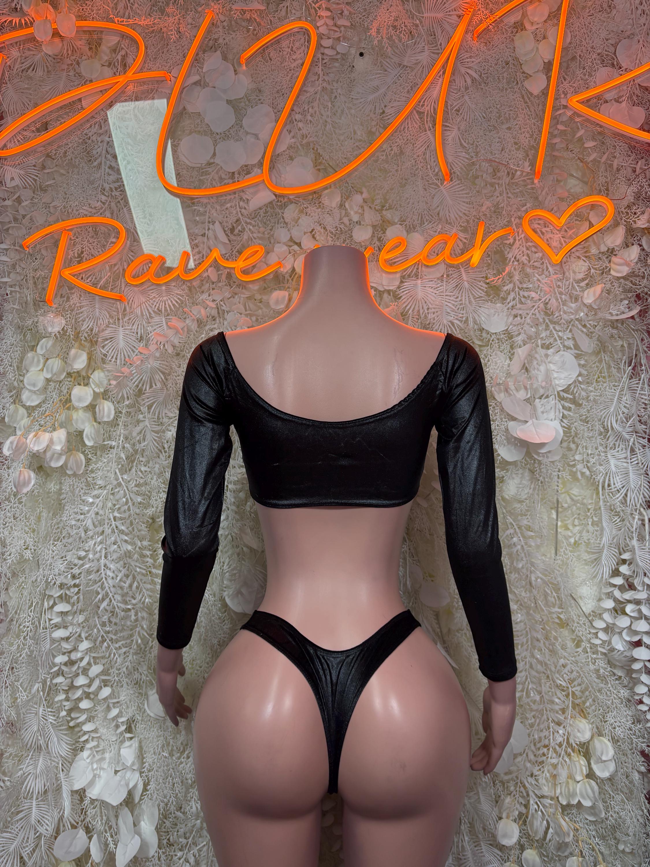 Black long-sleeve crop top with open back and high-cut bikini bottoms.