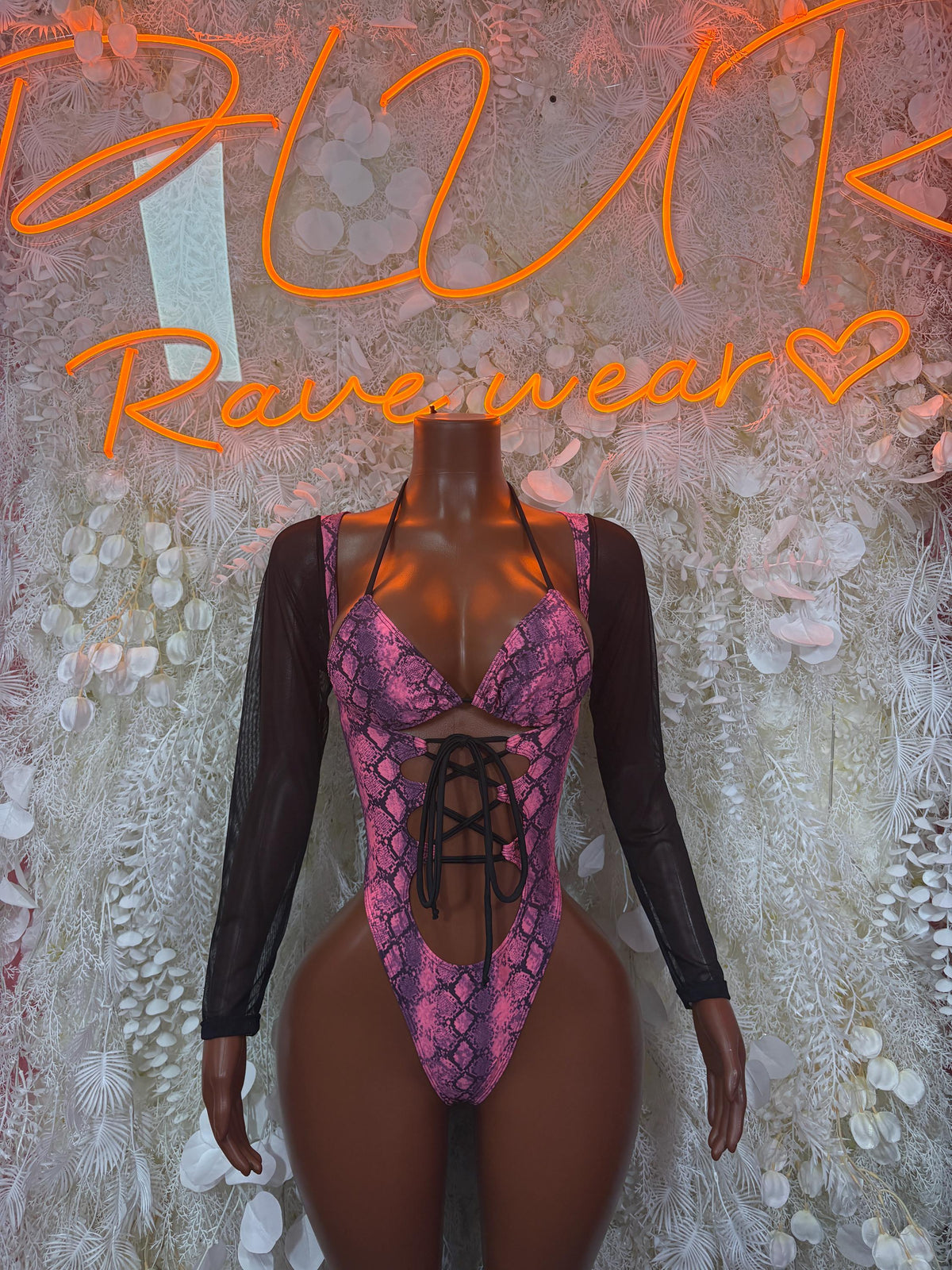 Long-sleeve one-piece bodysuit with purple snake print, lace-up front and sheer black sleeves