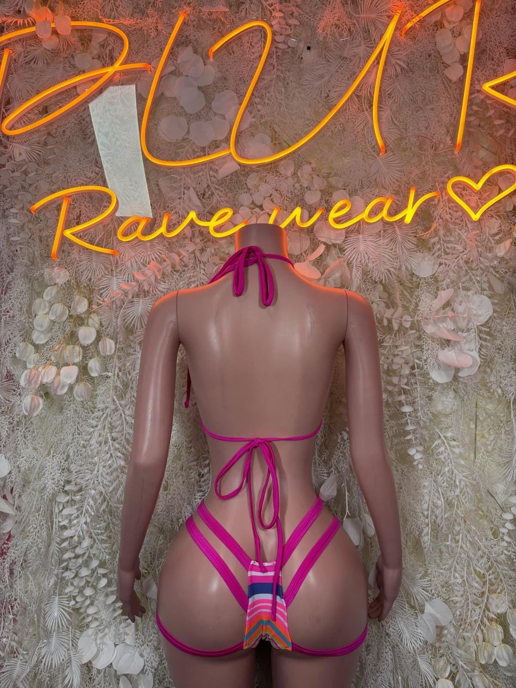 Back view of strappy rave bikini with multicolor striped triangle top and magenta ties