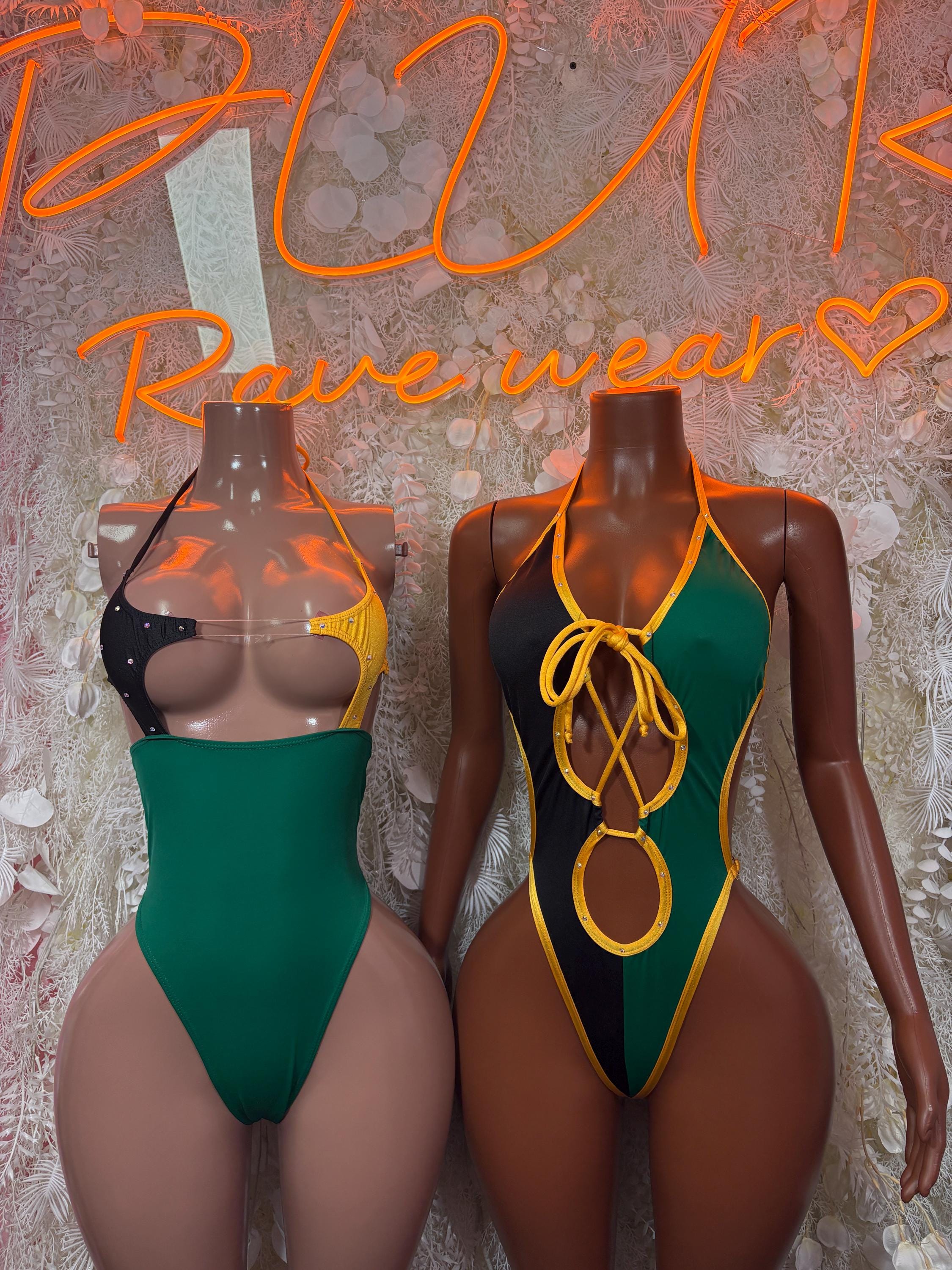 Jamaica-flag bodysuit set on two mannequins: green body with black and yellow lacing