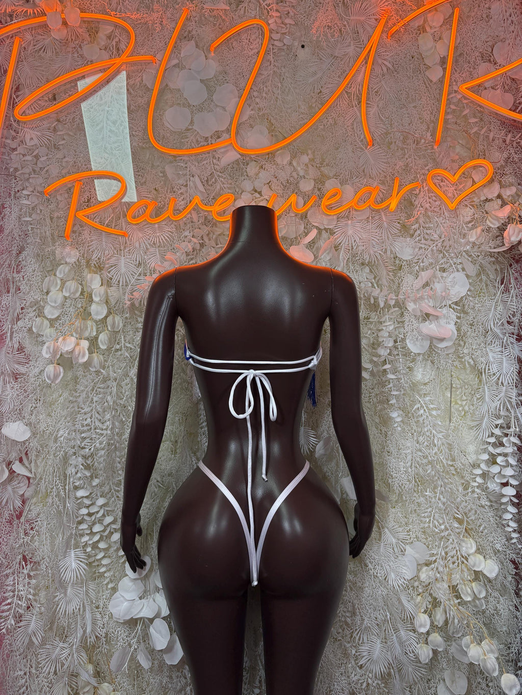 Women’s one-piece swimsuit back view in white and blue with string ties and trim