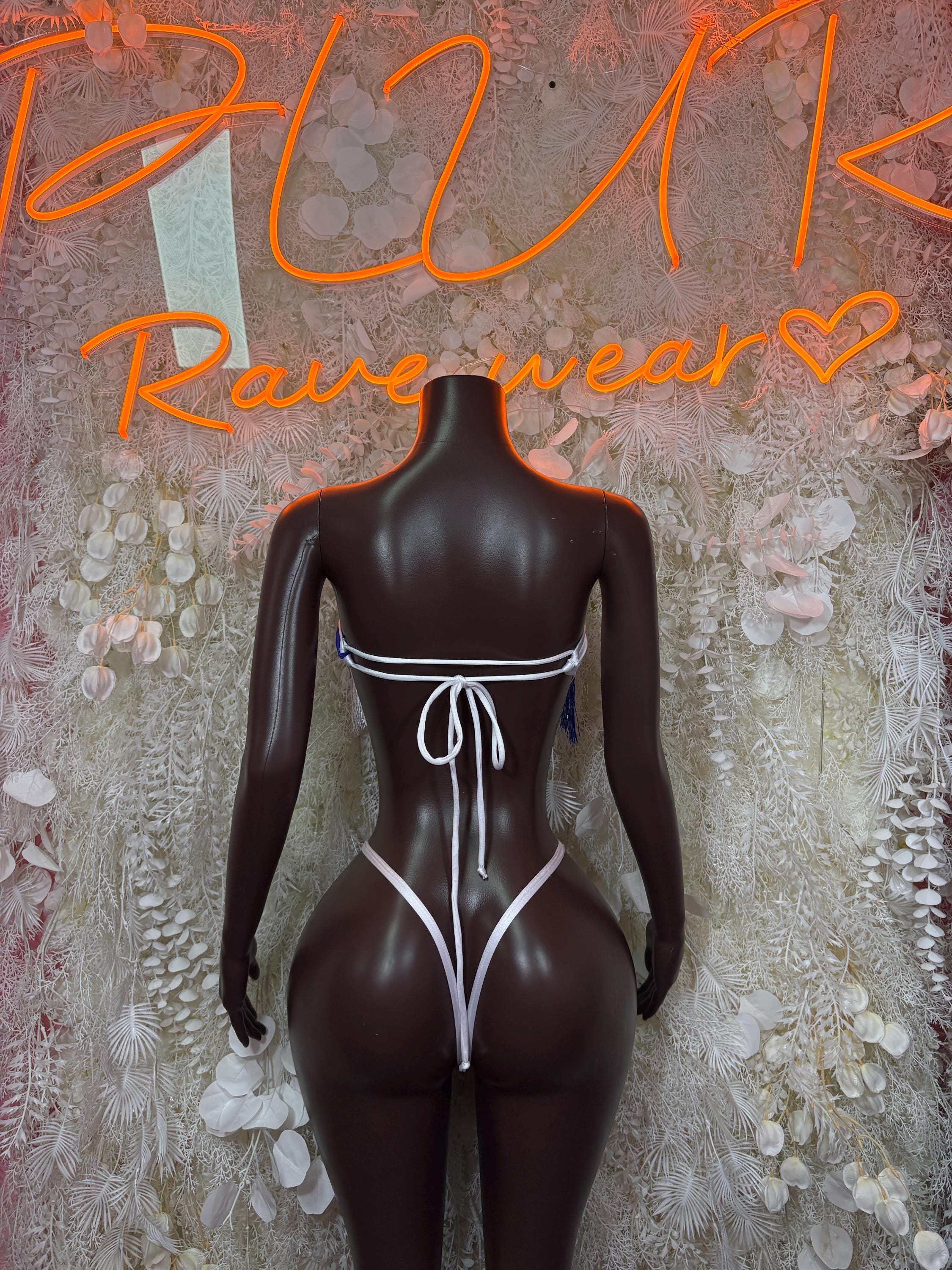 Women’s one-piece swimsuit back view in white and blue with string ties and trim