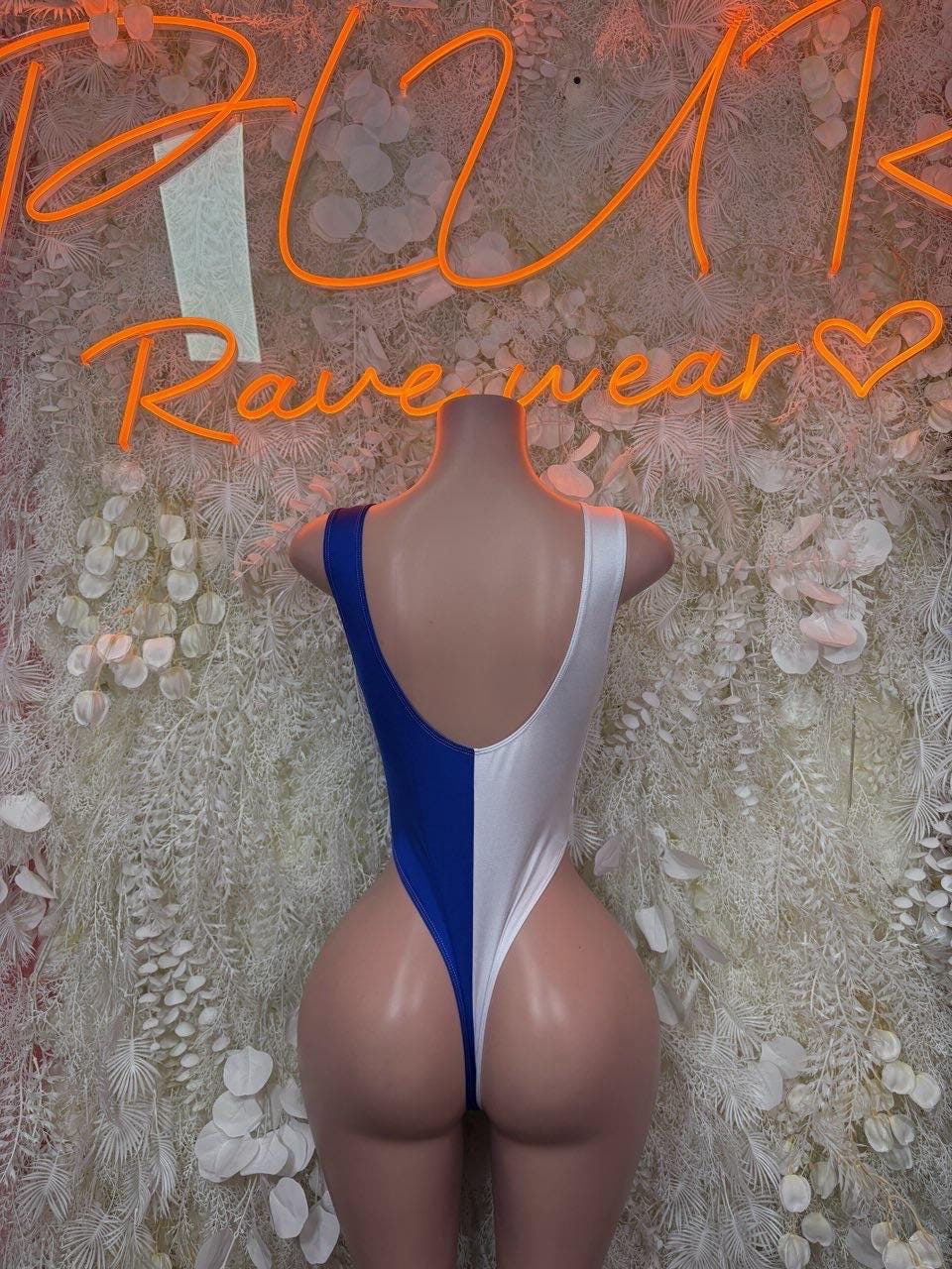 Women’s one-piece swimsuit in blue and white, open back and high-cut legs.