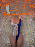 Women’s one-piece swimsuit in white and blue, lace-up front with high-cut legs.