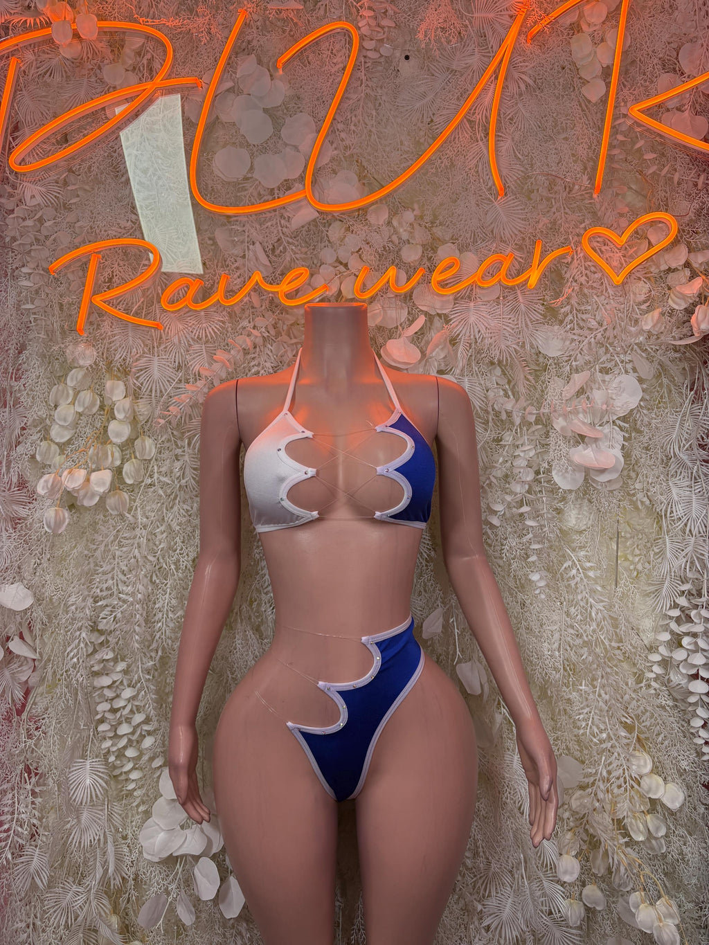 Two-piece bikini with white-and-blue scalloped panels and tie-back string top, front view