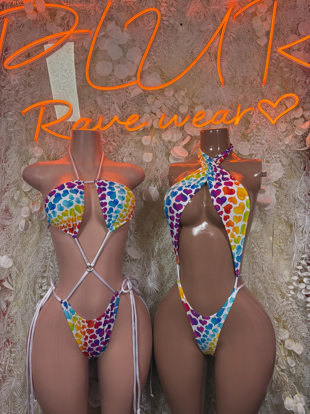 Rainbow hearts one-piece bodysuit on two models, crisscross straps and open back