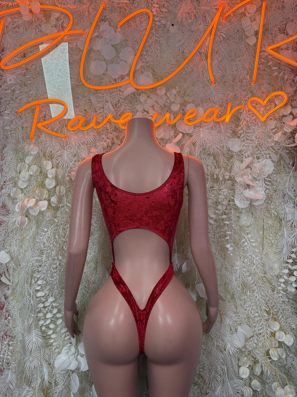 Red sleeveless one-piece bodysuit with scoop neckline and high-leg cutout