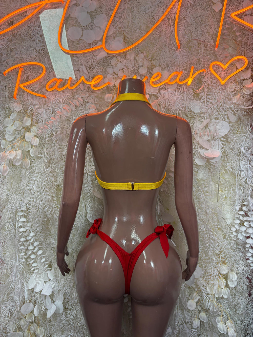 Back-view bikini set with yellow cross-strap top and red side-tie bottoms