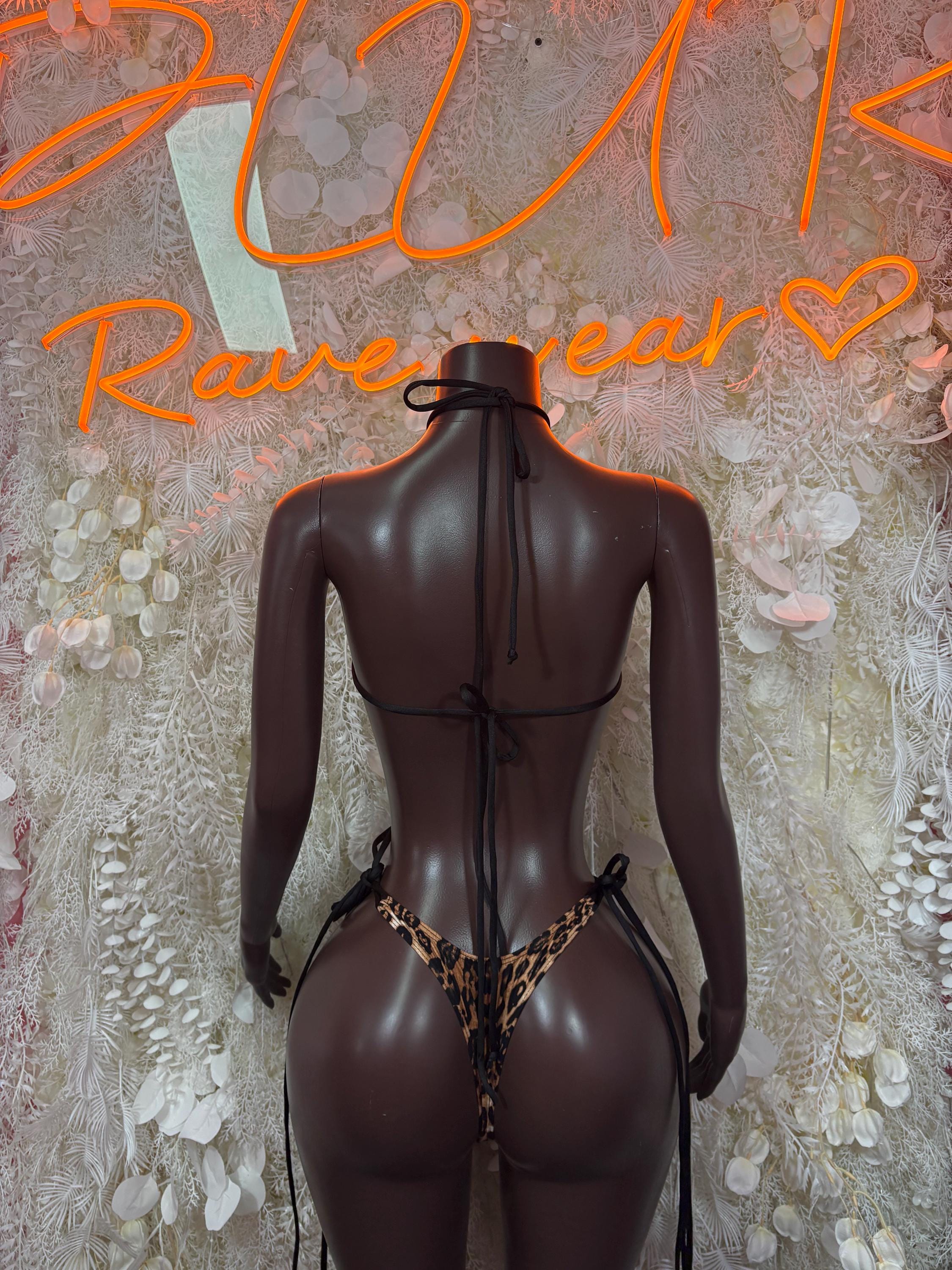 Leopard print one-piece bodysuit with low back and crisscross strap detail, thong cut