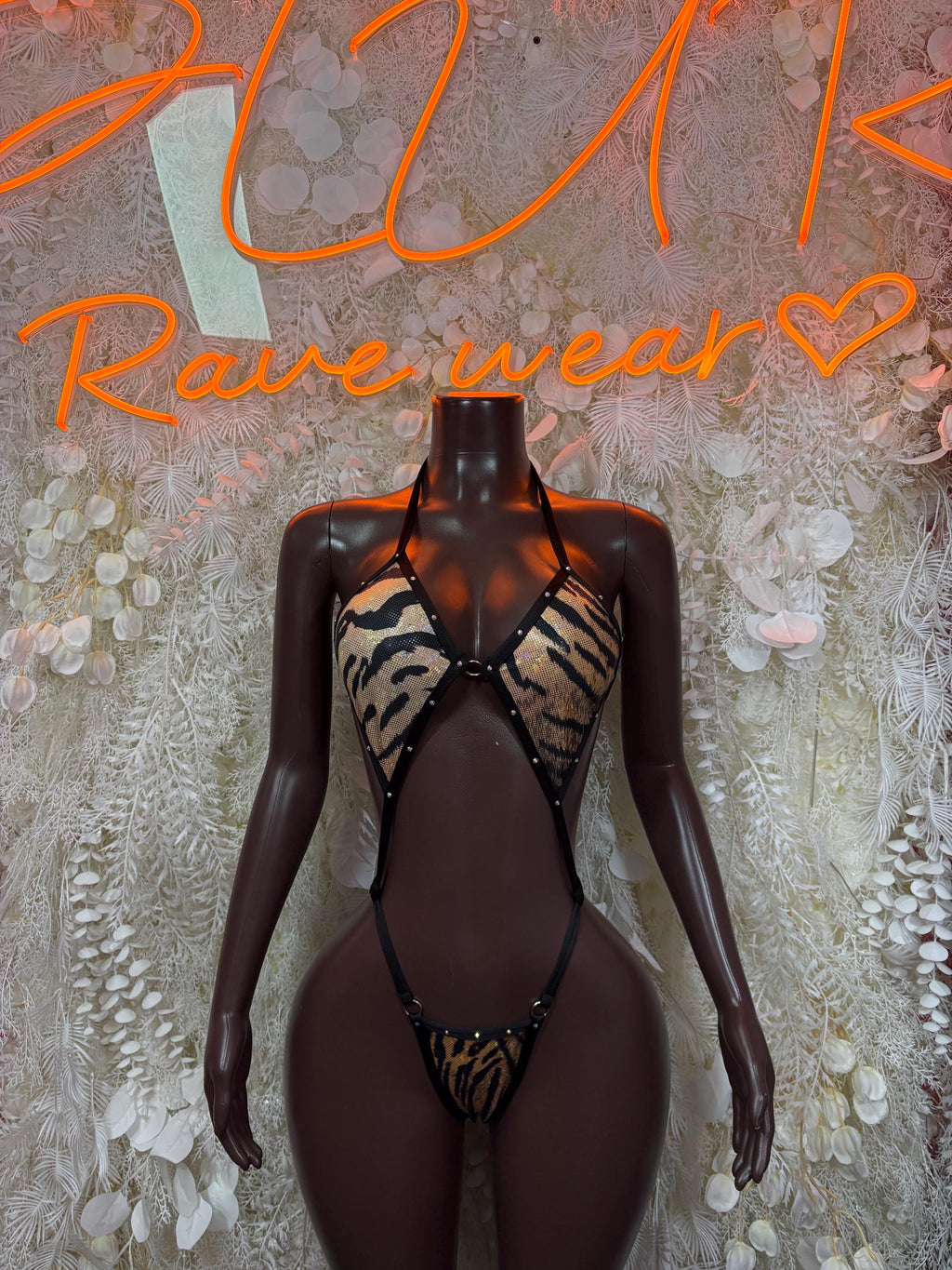 Tiger-print halter bodysuit with open sides, front hook closure, black mesh lingerie