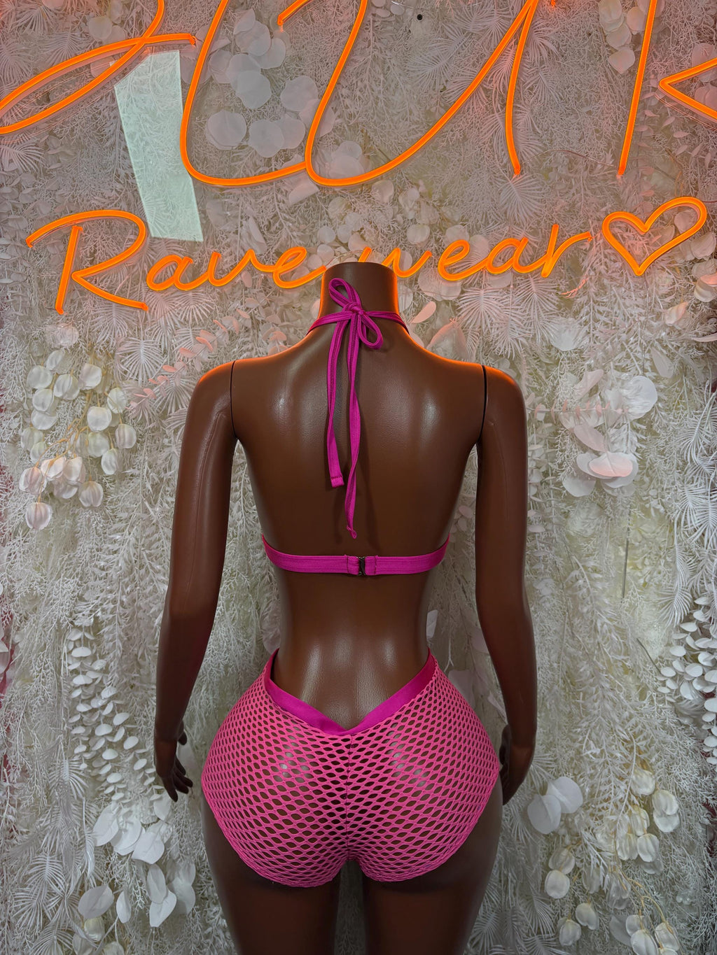 Pink fishnet two-piece rave set back view with tie halter bra and shorts