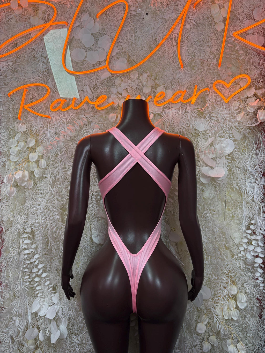 Pink bodysuit back with crisscross straps and V-shaped cutout