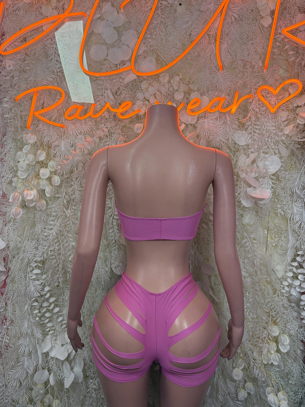 Pink bandeau top and high-waist shorts set with strappy cutouts, back view