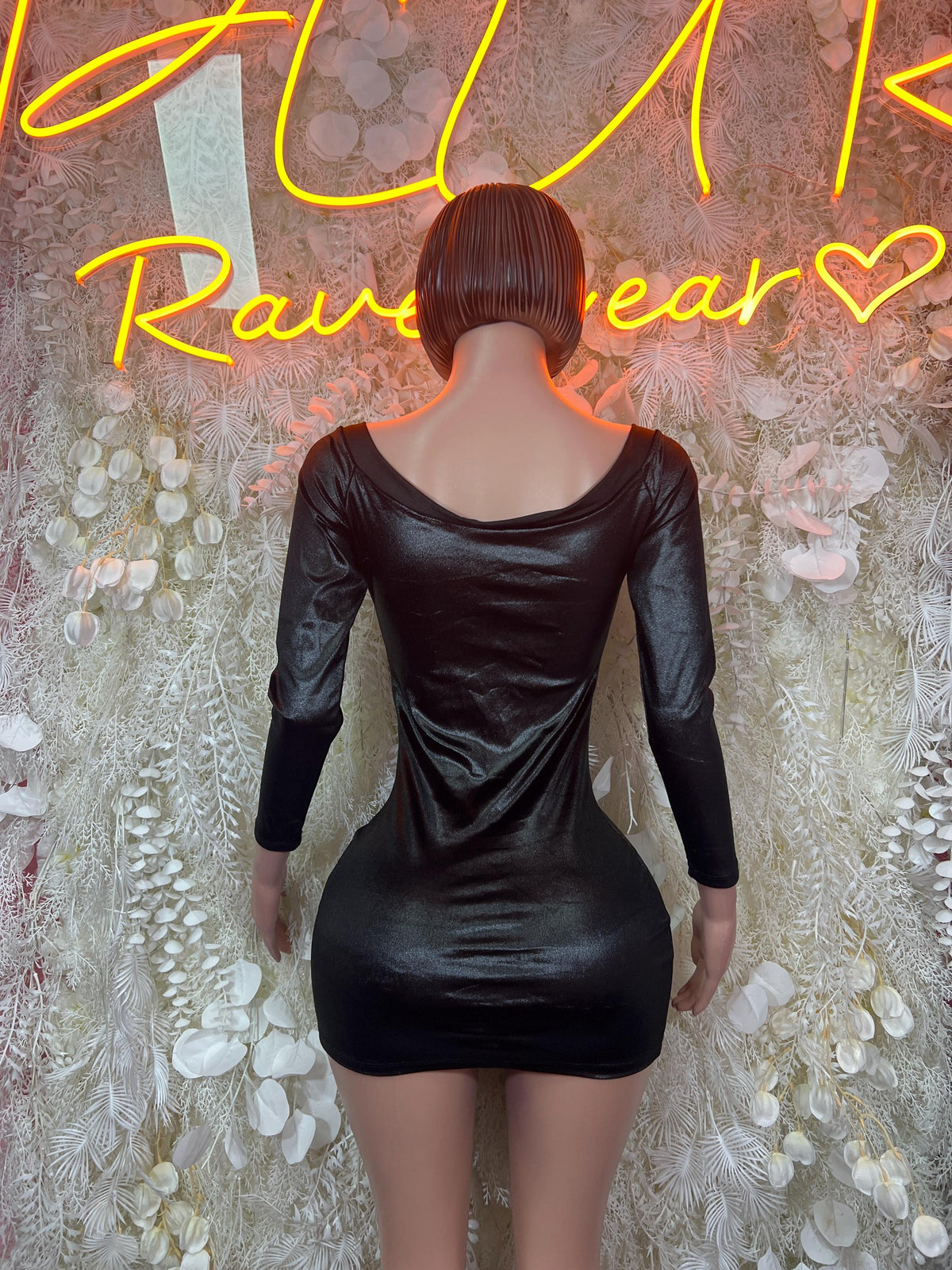 Black satin mini dress back view with open neckline and gathered waist seams