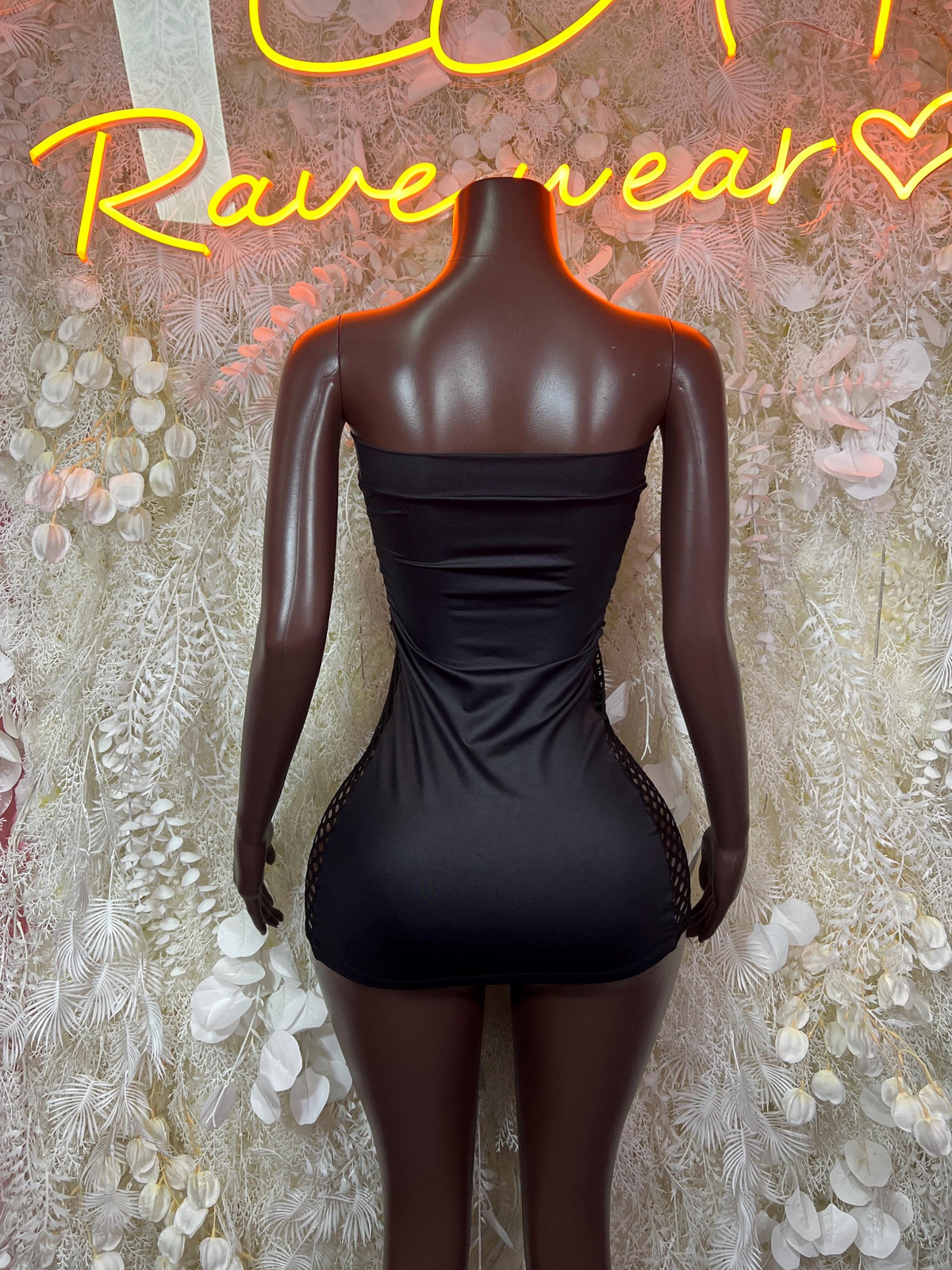 Black strapless mini dress back view with center seam and ruching
