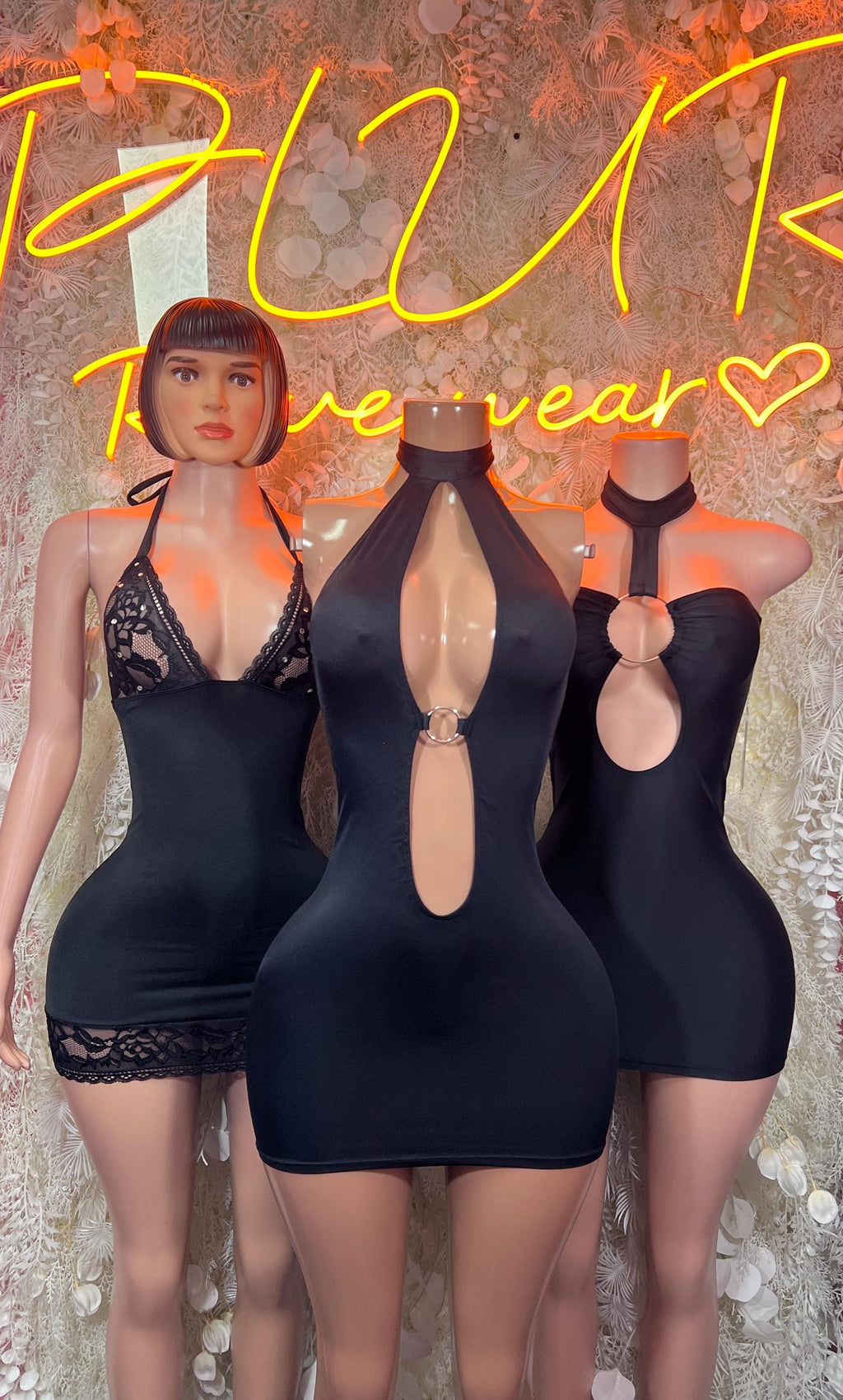 Black halter mini dress with keyhole front cutout, lace trim, and metal ring