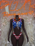 USA flag bodysuit with star print, lace-up front, and striped bottom; long black sleeves