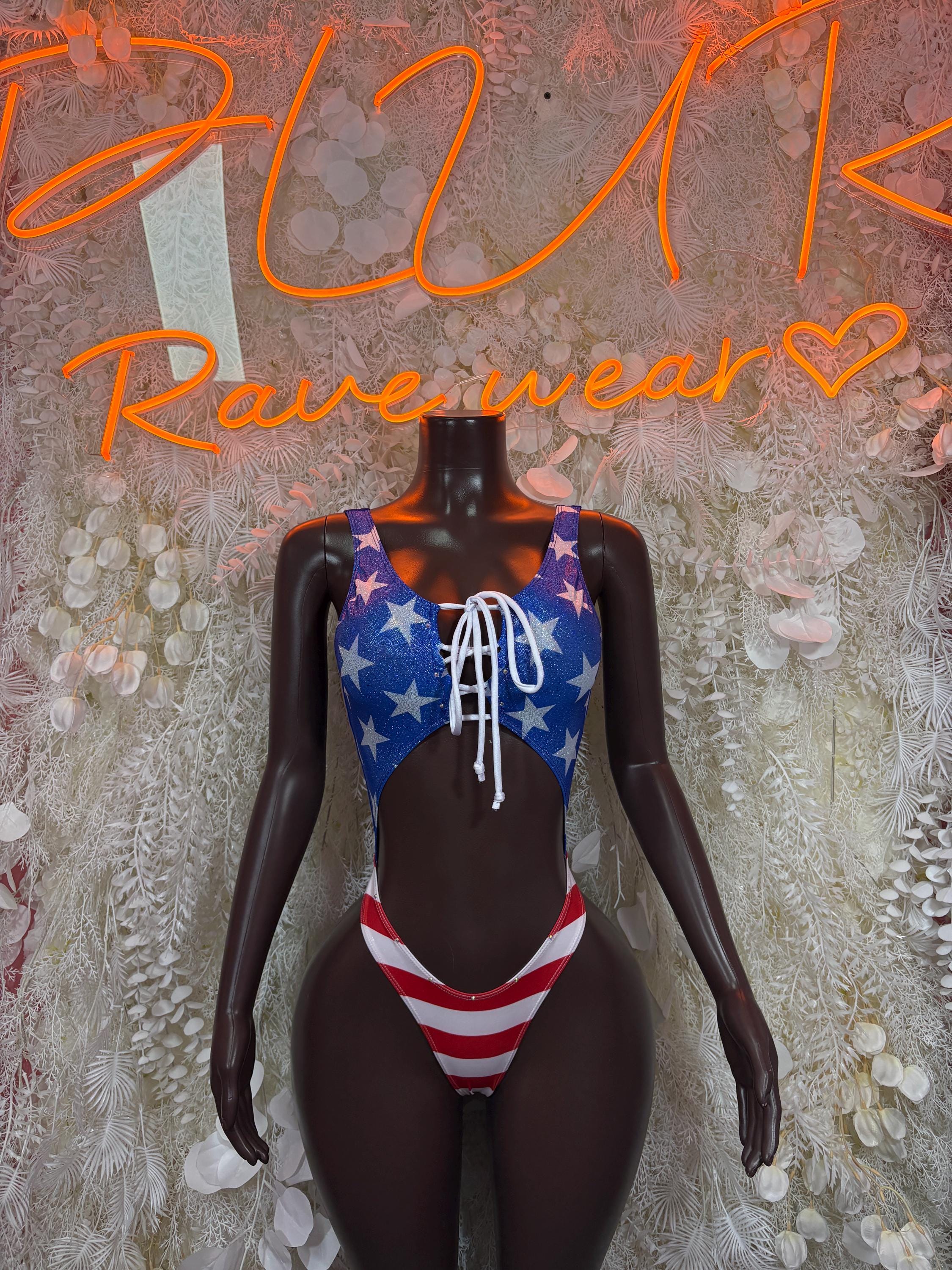 USA flag bodysuit with star print, lace-up front, and striped bottom; long black sleeves