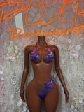 Purple metallic two-piece dance costume with blue trim and cheeky thong cut