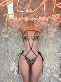 Leopard-print lace-up bodysuit with sheer side panels and black tie straps