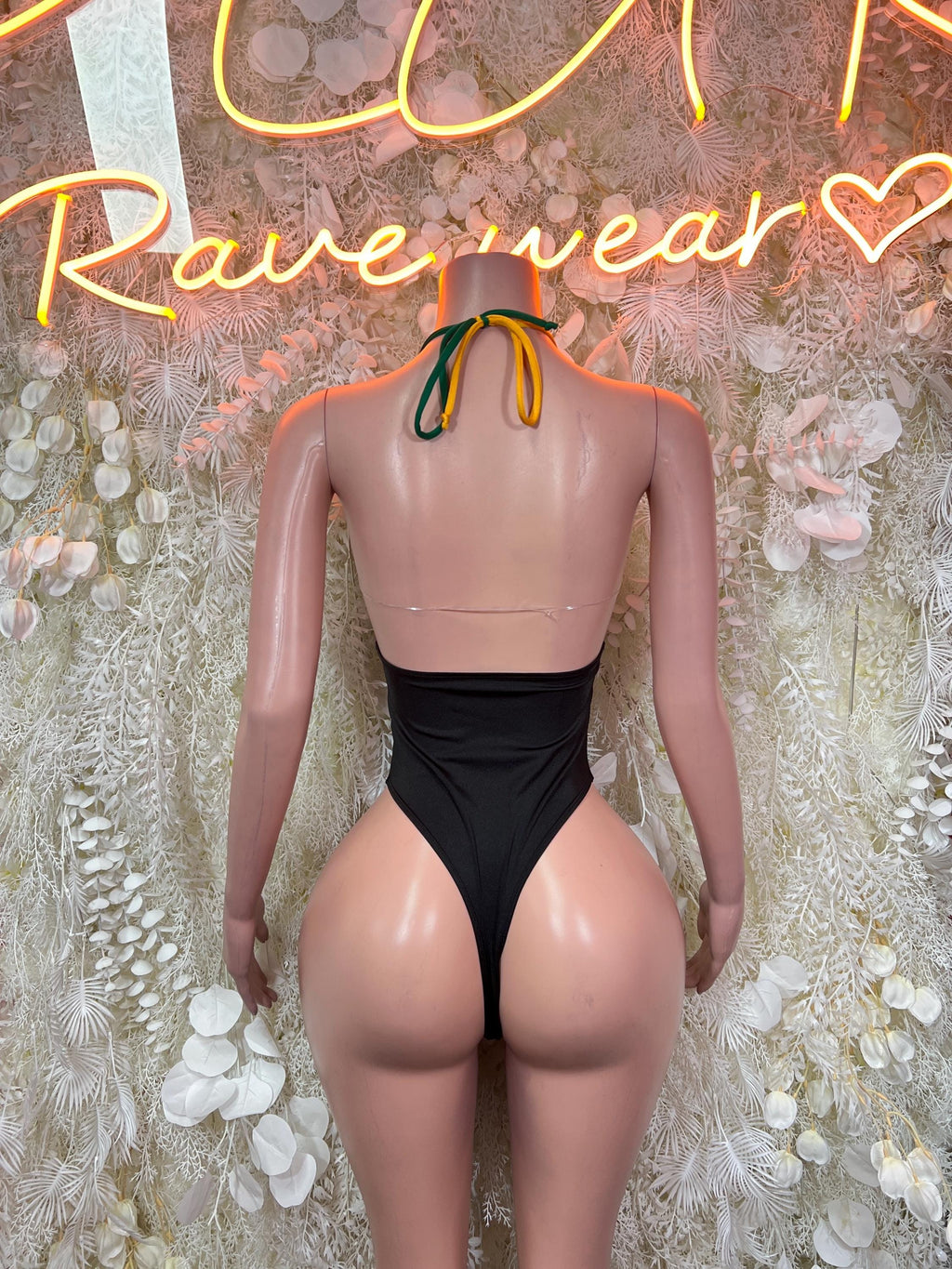 Back view halter bodysuit, black with green and yellow panels and tie at neck