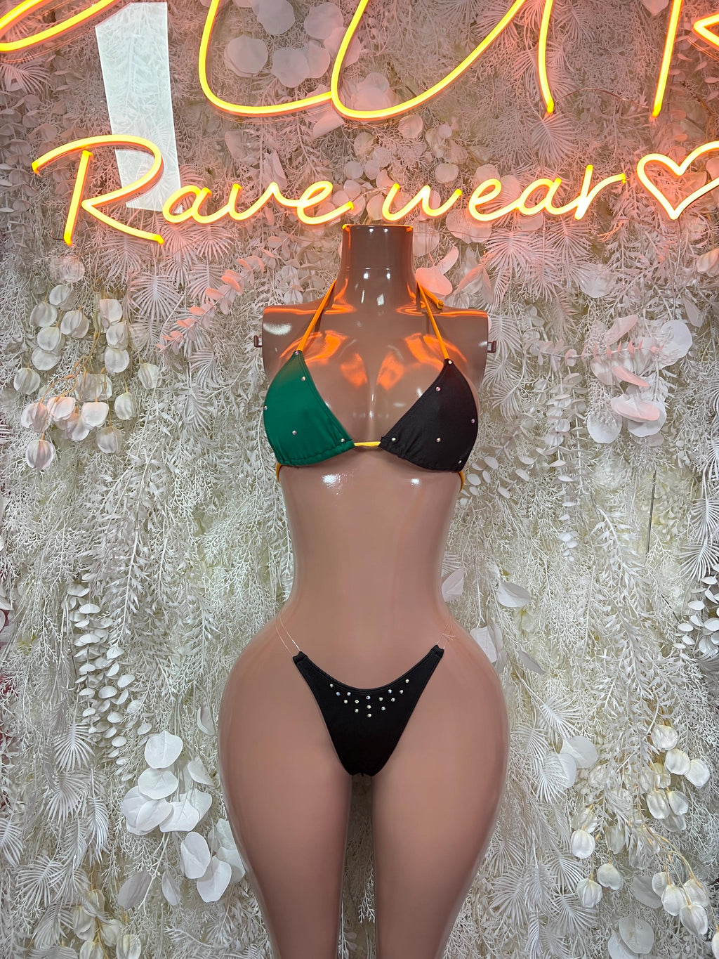 Two-piece bikini with green and black triangle top and matching tie-side bottoms