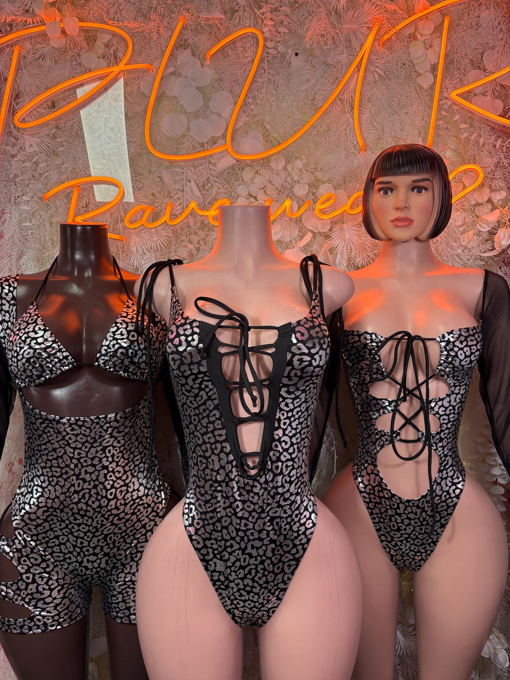 Black cheetah-print one-piece bodysuit with deep V lace-up front and shoulder ties