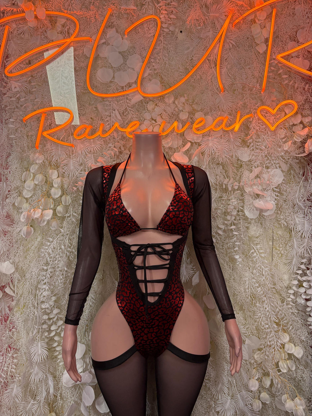 Red cheetah-print bodysuit with black mesh long sleeves, front crisscross lace-up