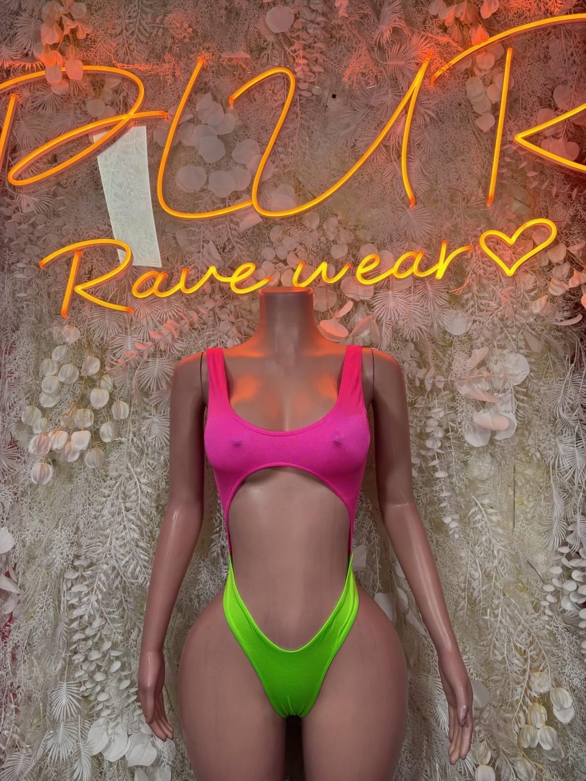 One-piece bodysuit with bright pink scoop neckline and neon green high-cut bottom