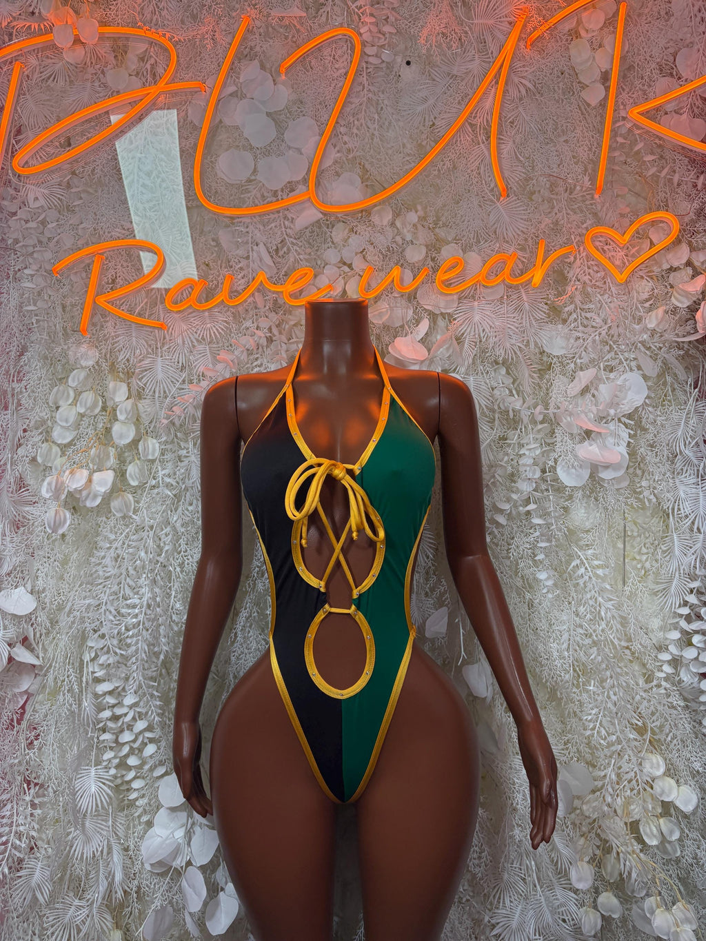 One-piece carnival bodysuit with green and black panels, yellow lace-up trim at chest