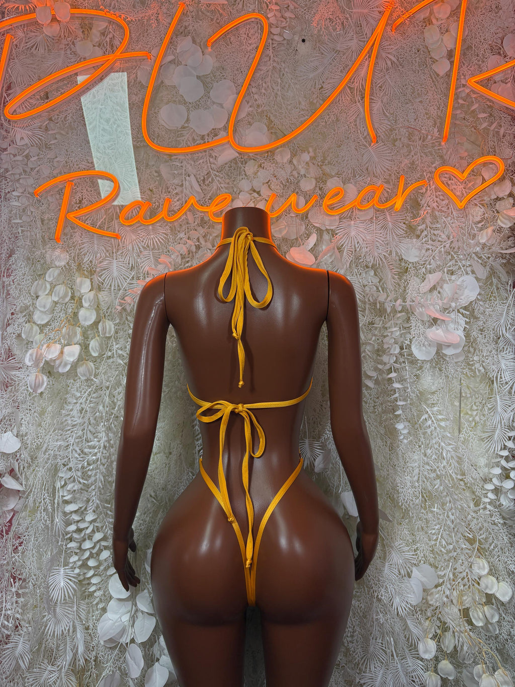 Back view one-piece carnival bodysuit in green and black with yellow tie strings