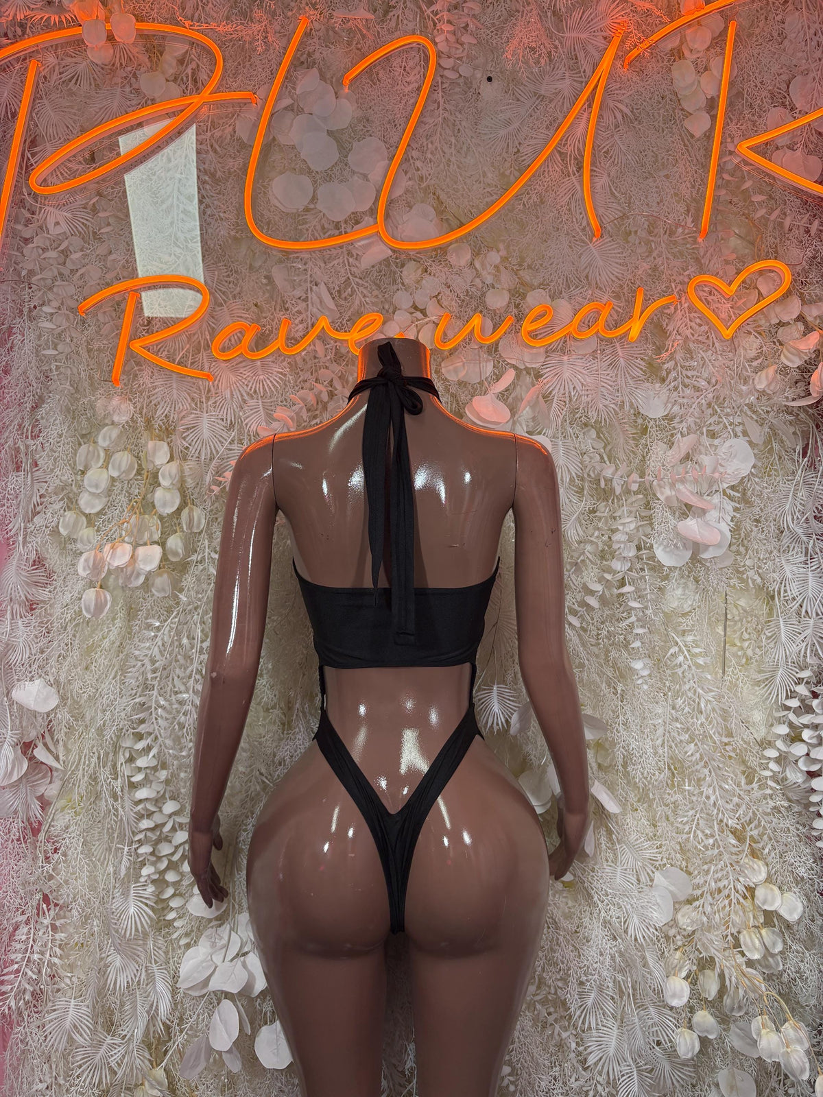 Black two-piece bikini with halter back, lace-style panels, back view