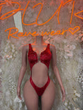 Red one-piece bodysuit with deep scoop neckline, studded detailing, high-leg cutout