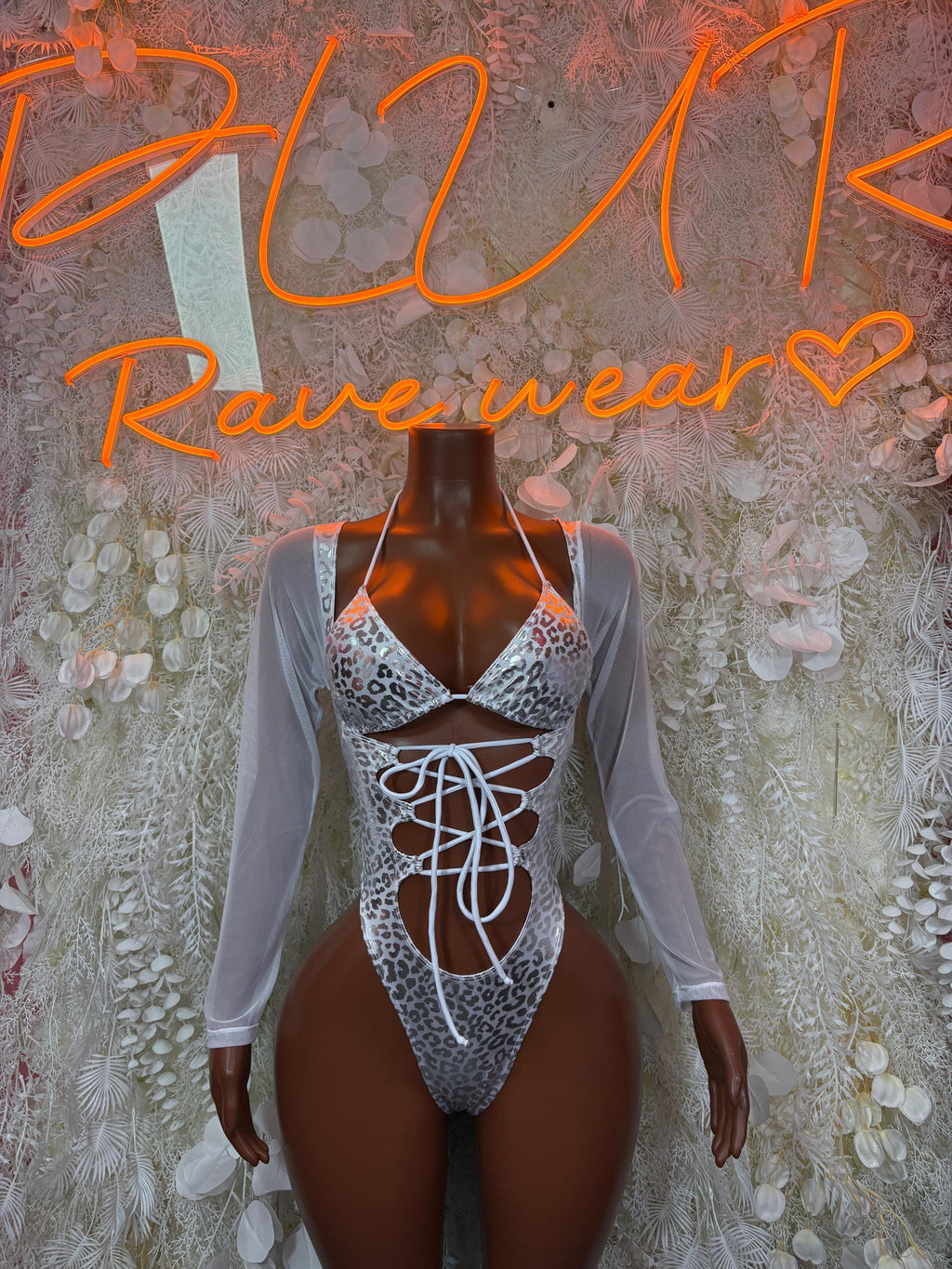 Silver cheetah print bodysuit with long sleeves and front lace-up cutout