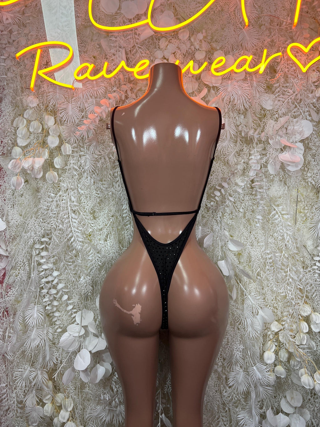 Black rhinestone backless bodysuit with V-shaped back and thong-cut legs