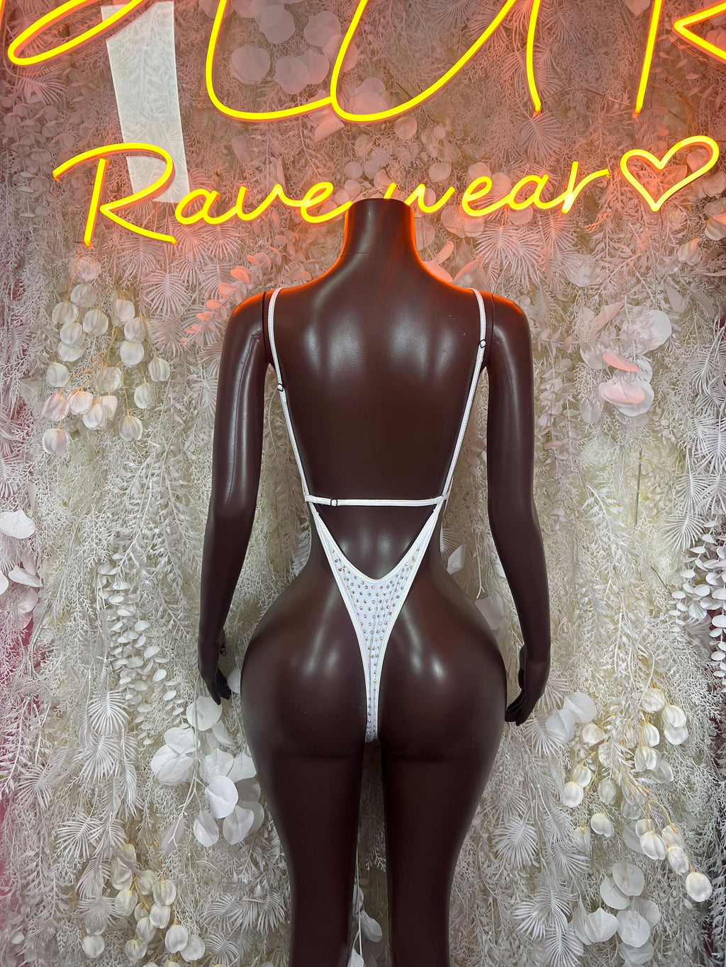 White rhinestone bodysuit with low V-back and thin straps, thong-cut bottom