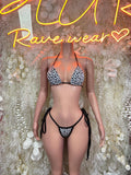 Two-piece bikini set with black-and-white polka dot triangle halter top and string bottoms
