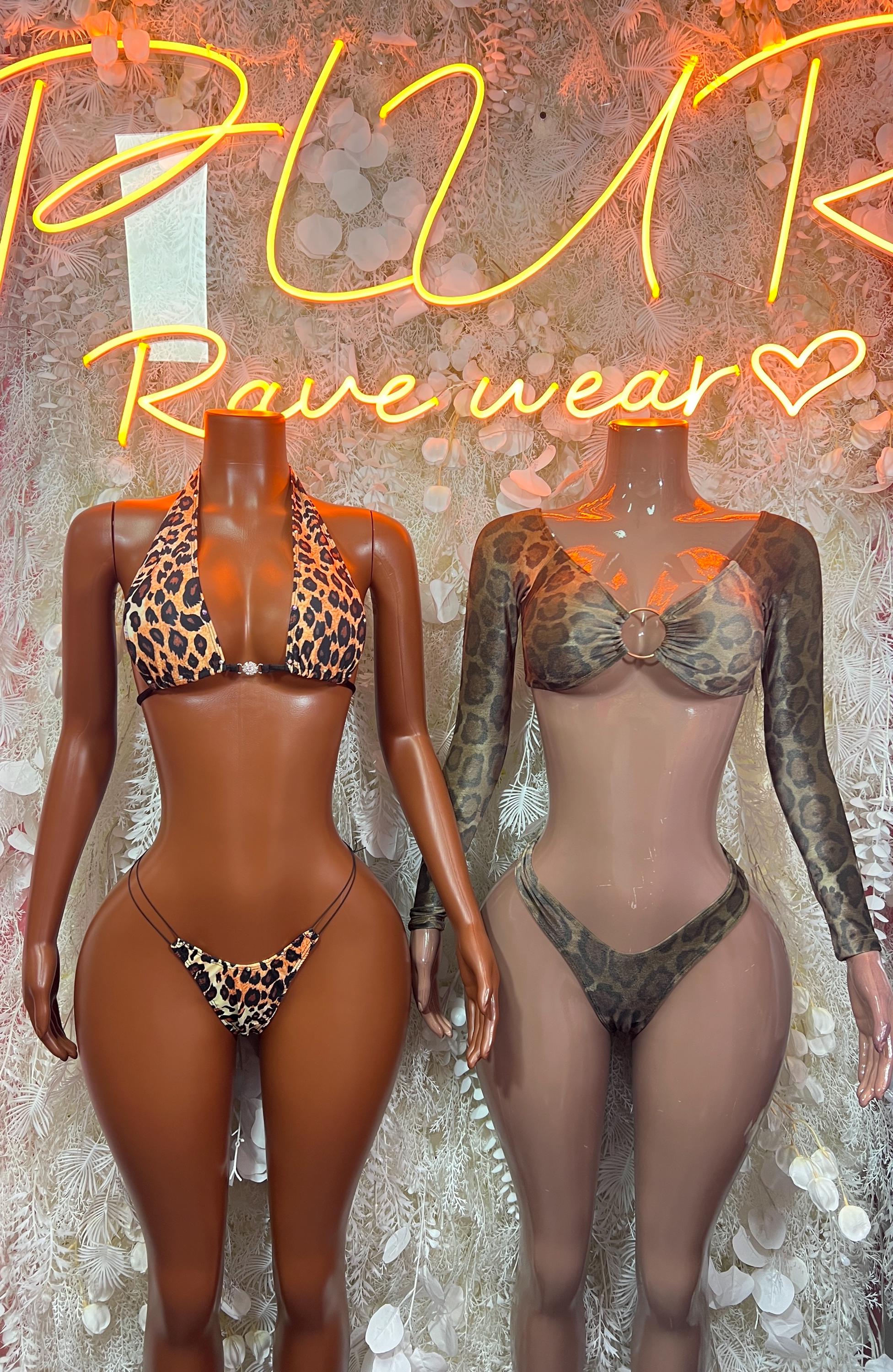 Two snake-print bodysuits on mannequins: dark olive and orange prints, high-cut bottoms