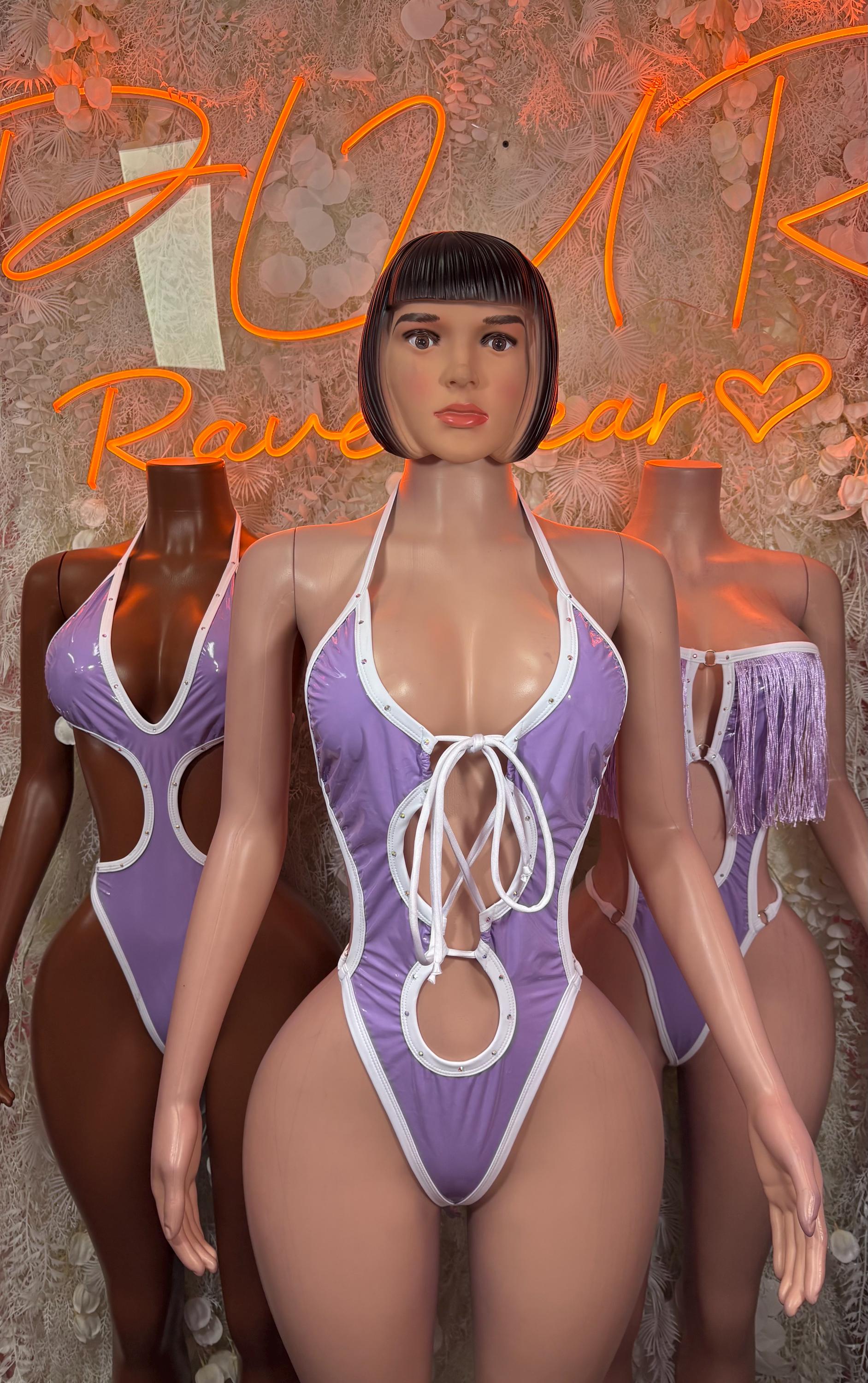 Purple halter bodysuit with white lace-up front and O-ring detail, shoulder fringe