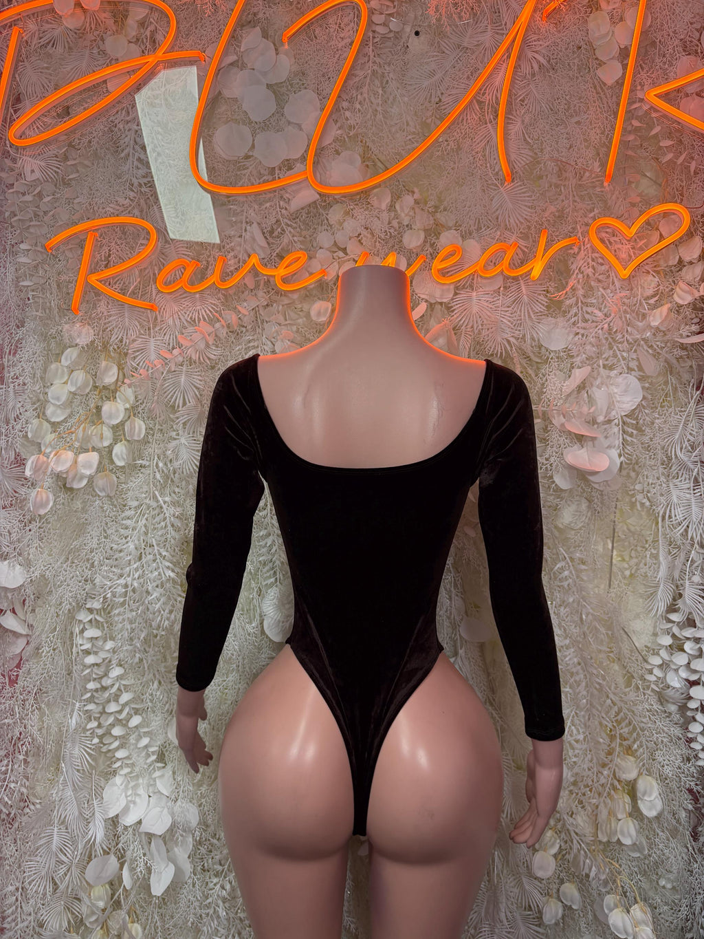 Dark velvet bodysuit with long sleeves, scooped back, and high-cut leg