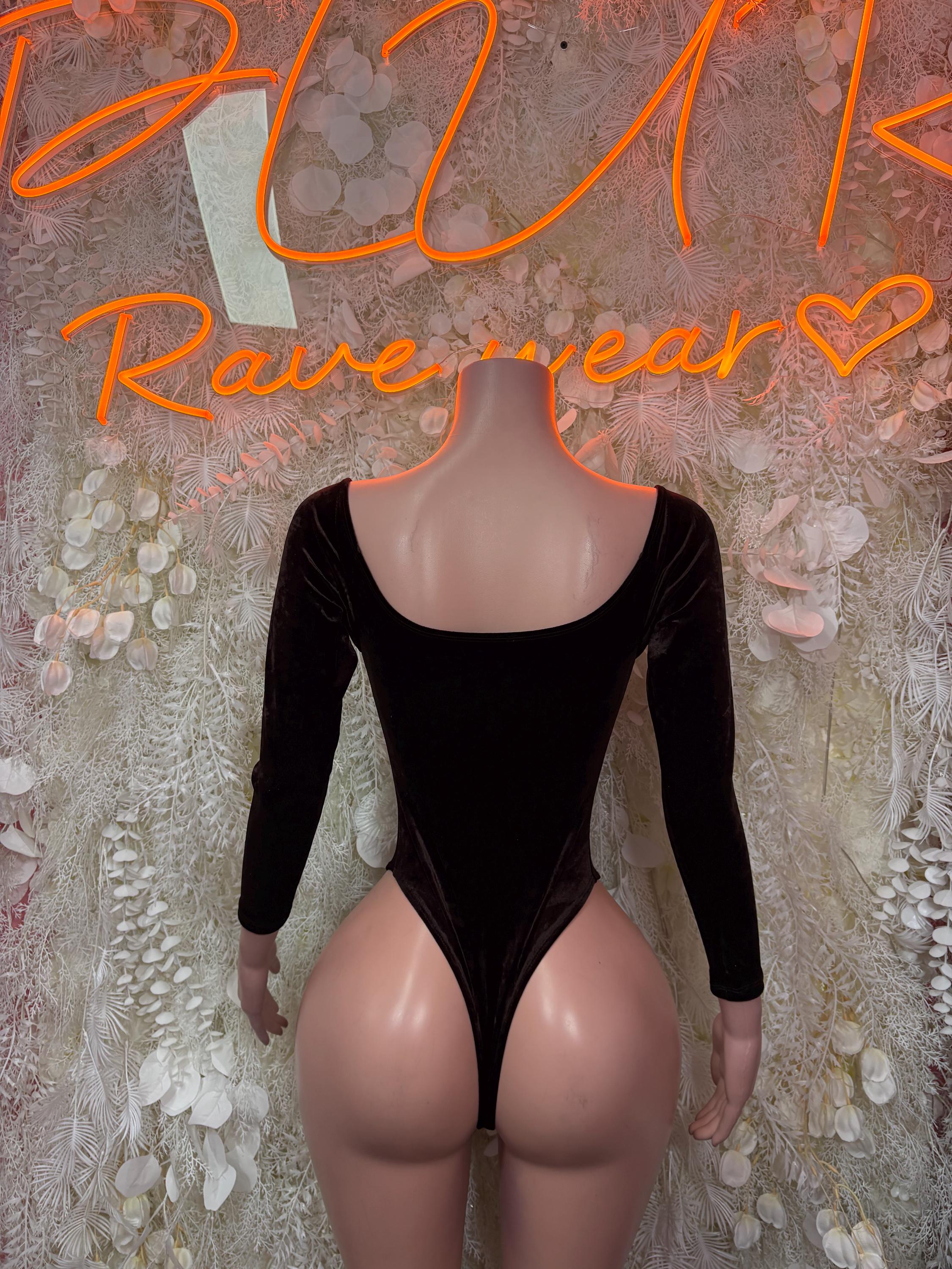 Dark velvet bodysuit with long sleeves, scooped back, and high-cut leg