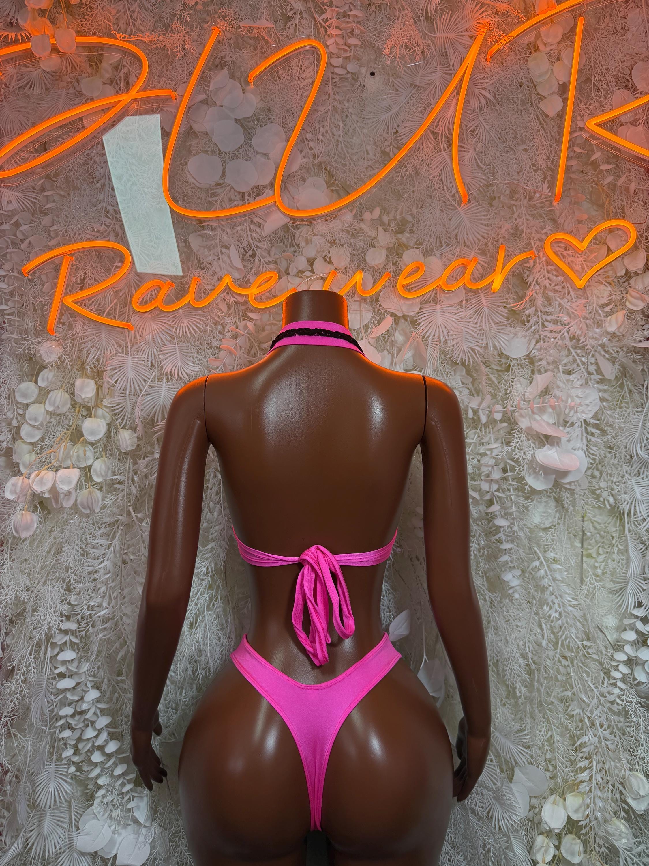 Pink-and-black rave two-piece set, back view: halter top with tie straps and thong