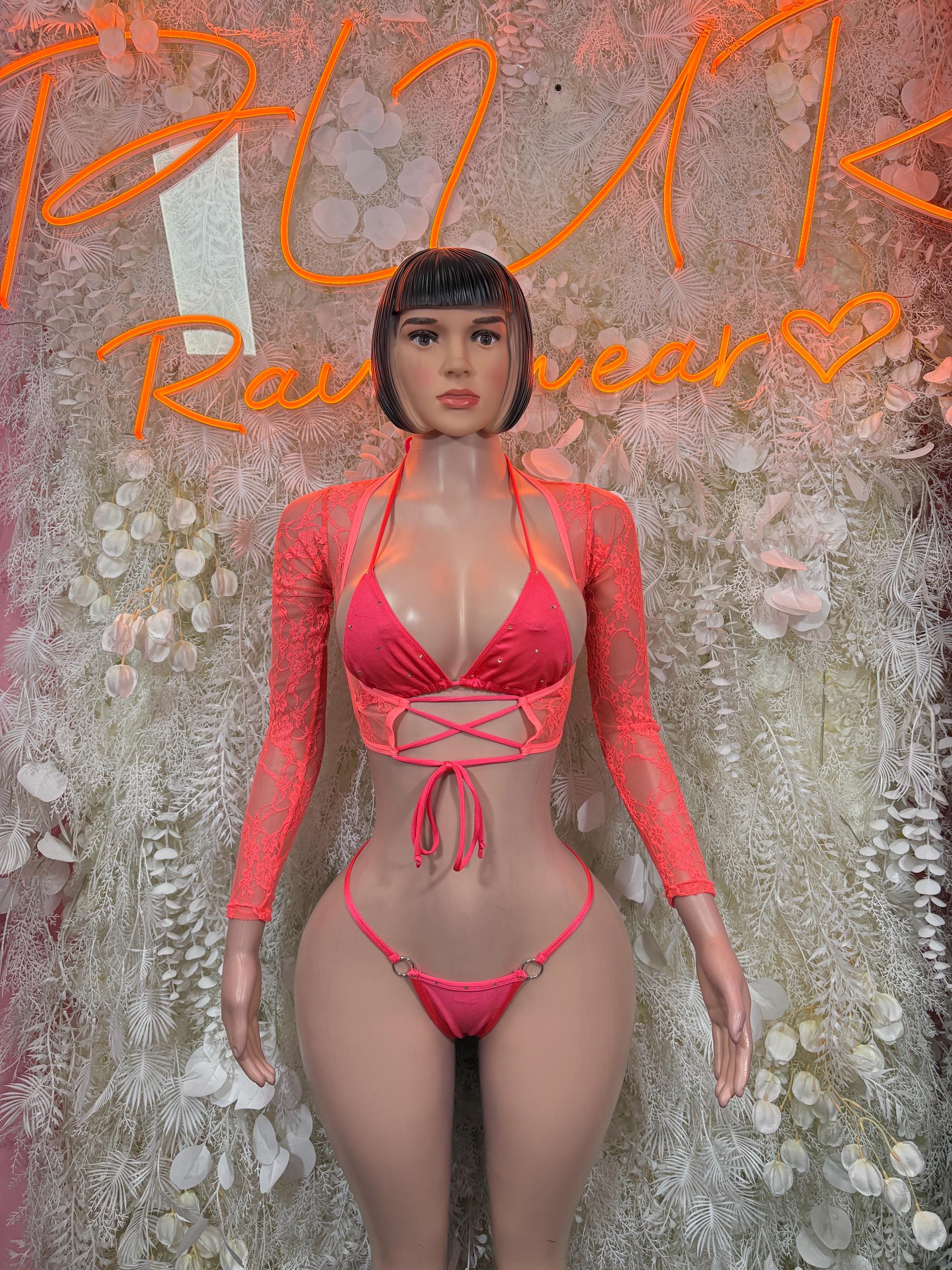 Coral two-piece dancewear set with long sleeves, lace bodice, and matching thong bottom