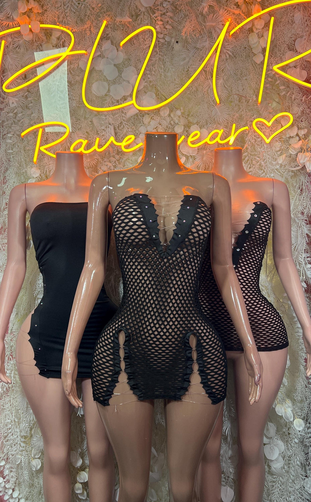 Black fishnet mini dress with deep V neckline, front view on mannequin