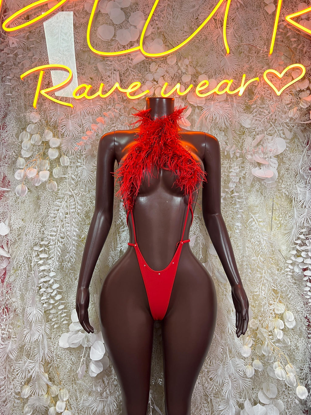 Red feather-trim bikini with tie string bottoms on mannequin, front view