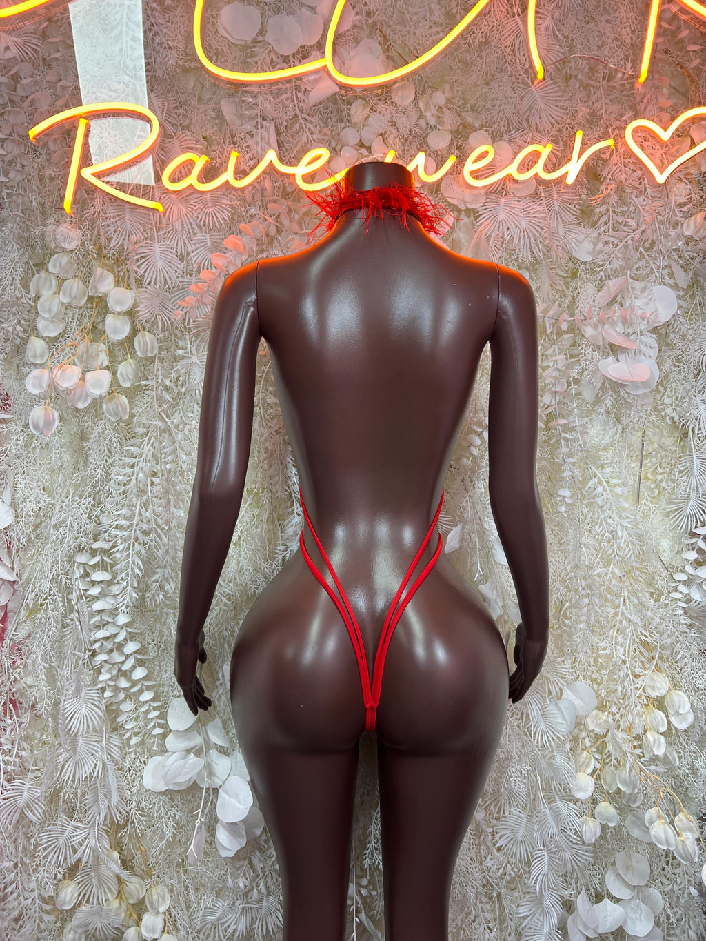 Red feather-trim bikini with V-back straps, rear view on mannequin