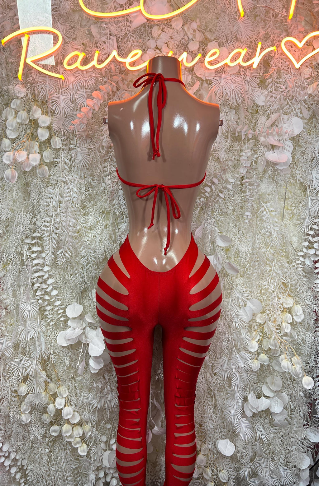 Red cutoff bodysuit with halter tie and open back, striped thigh cutouts