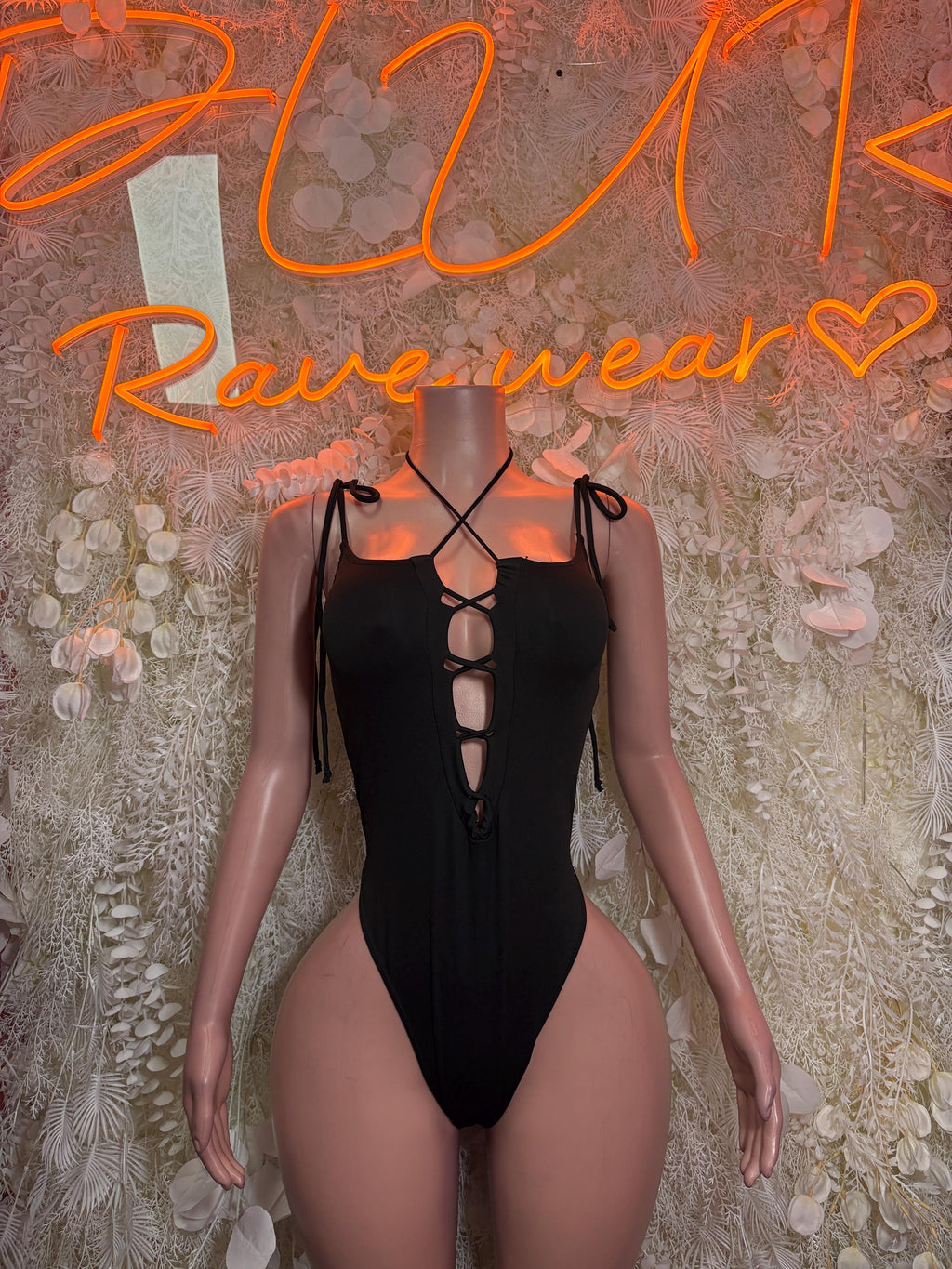 Black lace-up bodysuit with crisscross neckline and cheeky cutout back