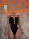 Black lace-up bodysuit with crisscross neckline and cheeky cutout back