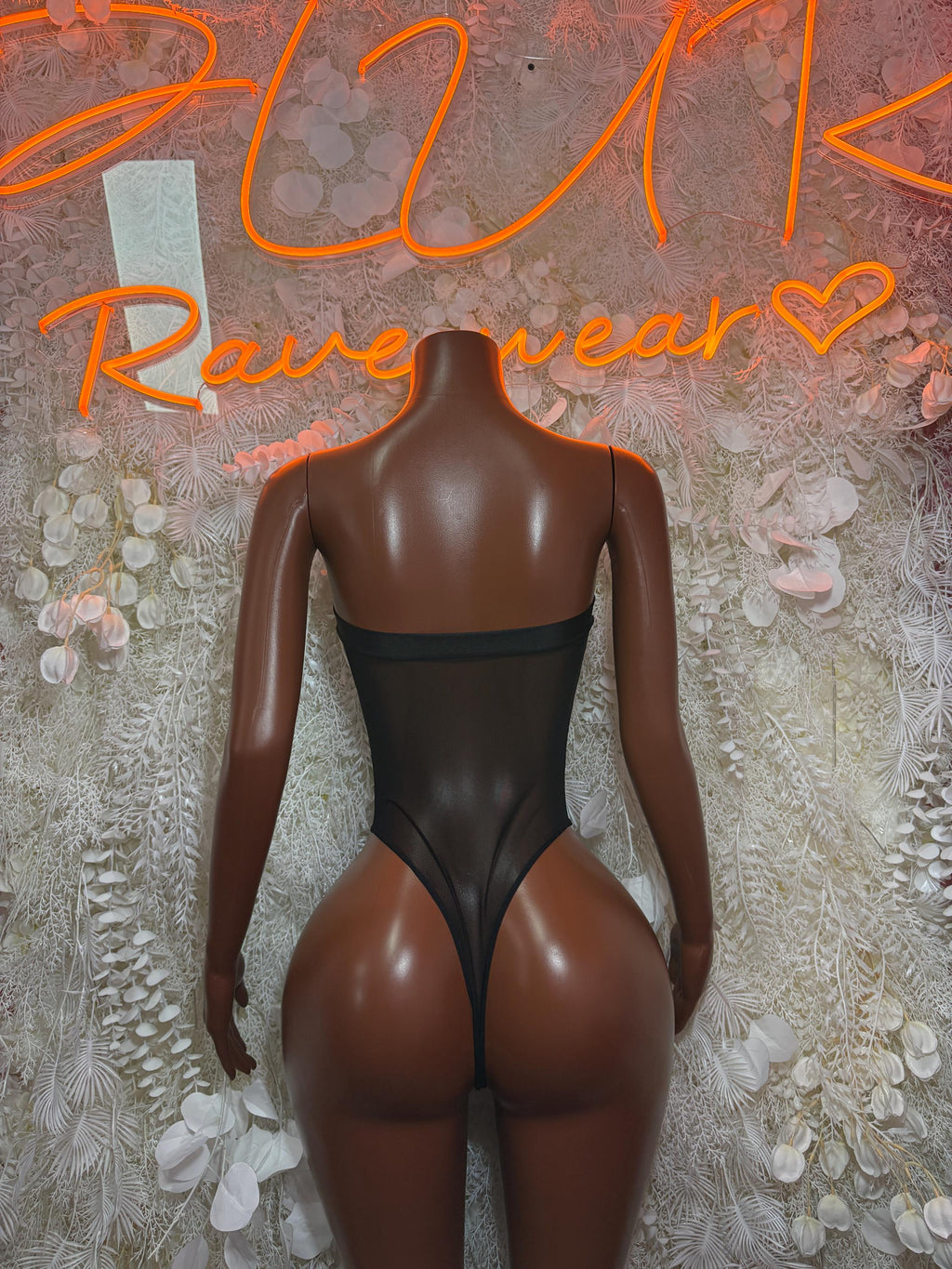 Black mesh bodysuit with open back and high-cut legs